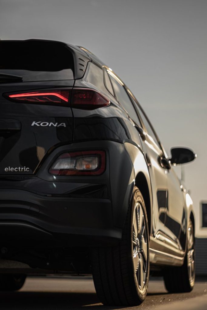 Vertical shot of a sleek Hyundai Kona electric car with stylish taillights.
